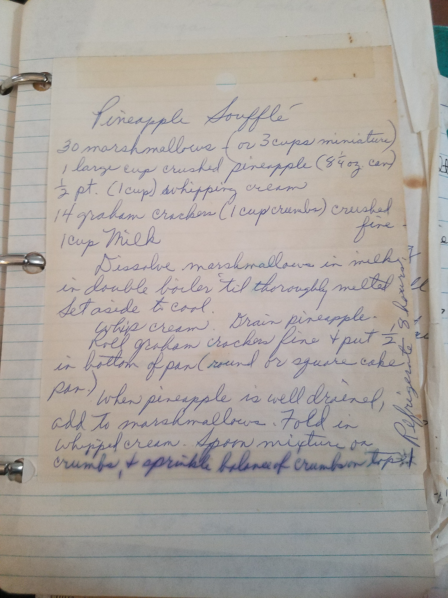 Handwritten pineapple souffle recipe on lined paper, featuring ingredients like marshmallows, pineapple, and graham crackers. The text is slightly faded.