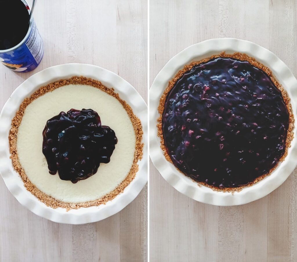 Spreading glossy blueberry pie filling over a smooth, white cream cheese layer in a graham cracker crust.