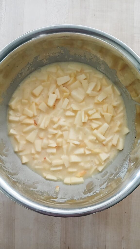 Diced apples mixed into the wet ingredients when making apple cake