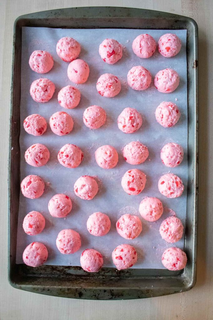 Frozen cherry mash candy filling rolled into smooth balls and ready for dipping in chocolate coating