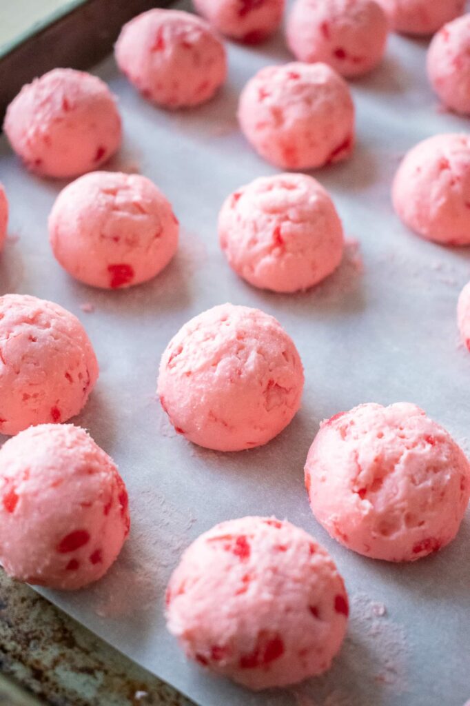 Frozen cherry mash candy filling rolled into smooth balls and ready for dipping in chocolate coating