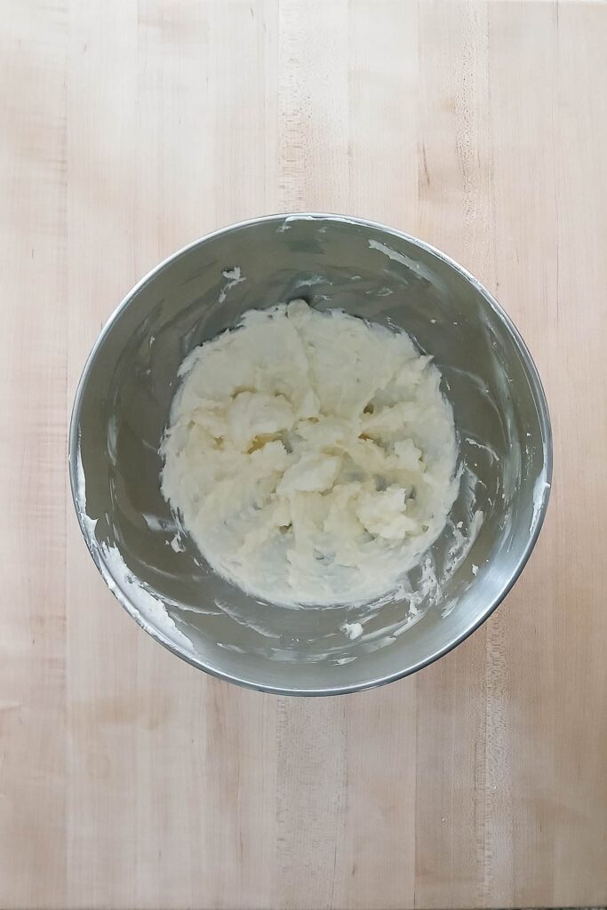 A stand mixer bowl showing the combined texture of butter and shortening