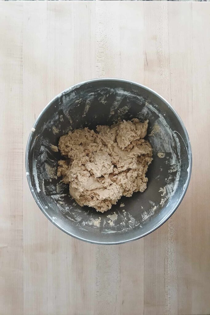 The cookie dough in a mixing bowl, looking soft and thick with no visible streaks of flour, perfectly mixed to ensure a tender cookie.